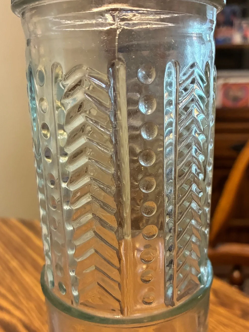 vintage glass spaghetti canister features an embossed circular logo